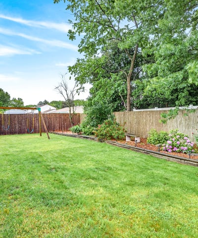 Backyard oasis with flower beds.