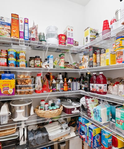 Spacious pantry with ample shelving, ideal for organized storage of food and household essentials.