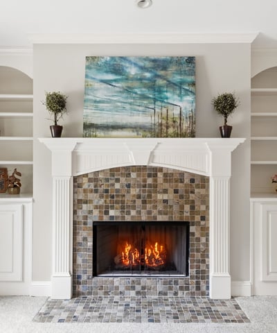 Cozy living room featuring a striking fireplace and built-in shelving for personalized decor.