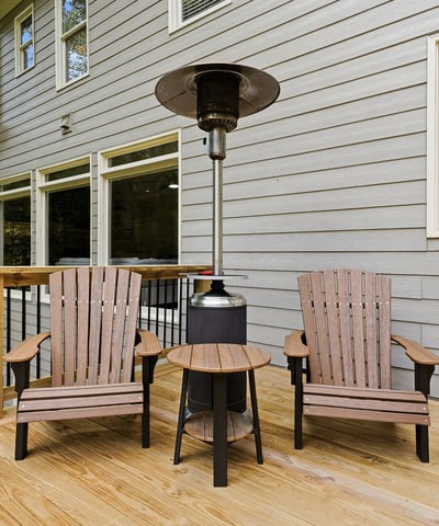 Cozy outdoor space featuring comfortable seating and a patio heater, perfect for year-round relaxation.