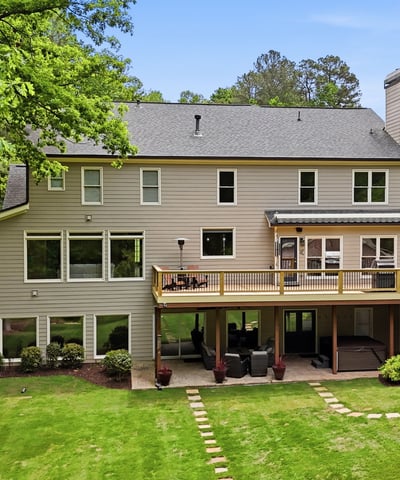Spacious home with expansive outdoor living and large windows, perfect for enjoying the surrounding nature.