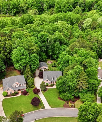Discover a landscaped community nestled among lush greenery, offering privacy and a peaceful suburban lifestyle.
