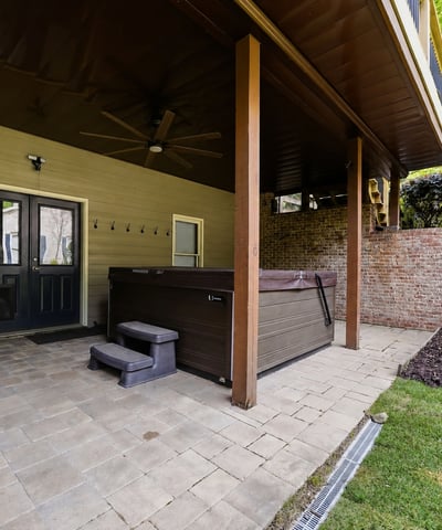 Discover this covered patio featuring a hot tub, perfect for outdoor relaxation and entertaining.