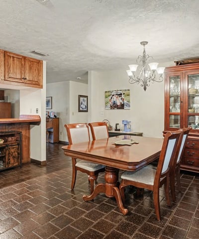 Dining area which can accommodate an eight-person table; the bar in the background opens to the Living Room.