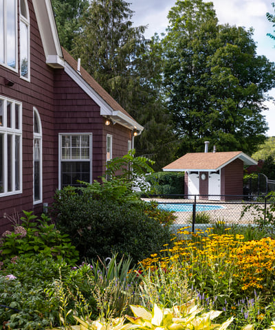 This inviting home features a lush garden, a private pool area, and picturesque outdoor views.