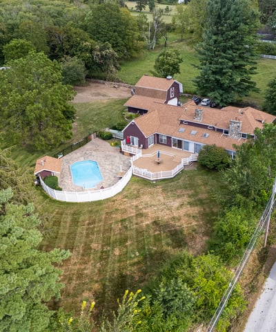 Spacious property featuring a pool, surrounded by lush greenery, perfect for outdoor activities and relaxation.