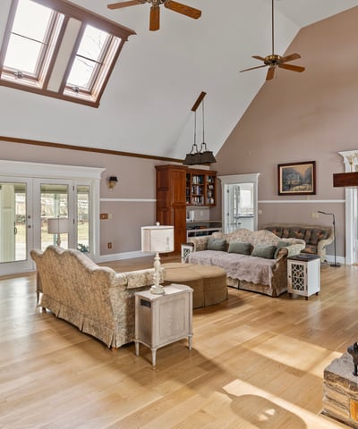 Spacious living area with large windows and unique architectural features, perfect for entertaining or relaxing.