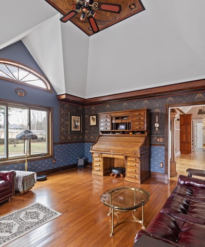 Spacious living area featuring unique architectural details and rich wood finishes, perfect for relaxation and gatherings.