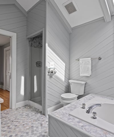 Bright and inviting bathroom featuring a soaking tub, walk-in shower, and modern finishes throughout.