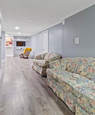 Bright and spacious lower level featuring a cozy seating area and convenient access to entertainment options.