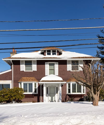Spacious two-story home with ample outdoor space, located in a peaceful, snow-covered neighborhood.