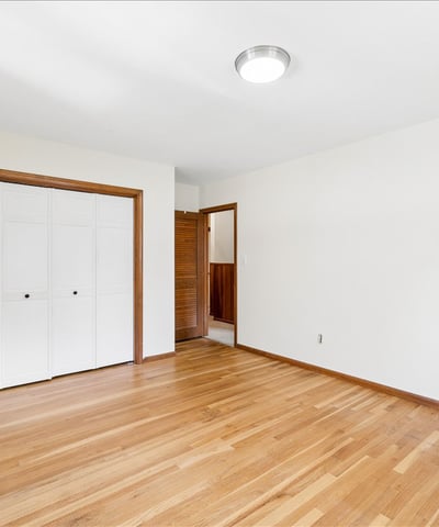 Spacious room featuring hardwood floors and ample natural light, perfect for customization or relaxation.