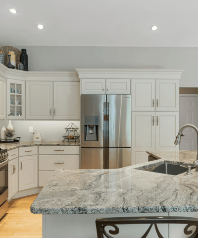 Modern kitchen with sleek granite countertops, stainless steel appliances, and ample cabinetry for convenient storage.