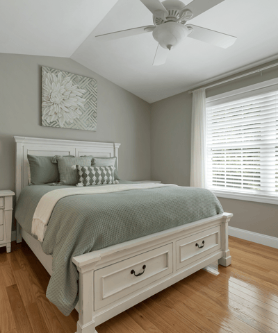 Bright and inviting bedroom featuring a cozy bed, modern furnishings, and abundant natural light.