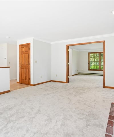 Spacious living area features cozy fireplace and connects seamlessly to the kitchen for easy entertaining.