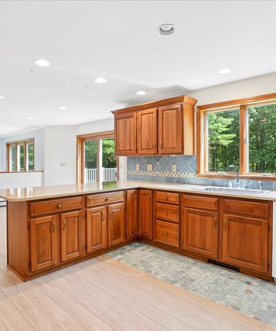 Spacious kitchen featuring warm wood cabinetry, ample natural light, and modern appliances, perfect for family gatherings.