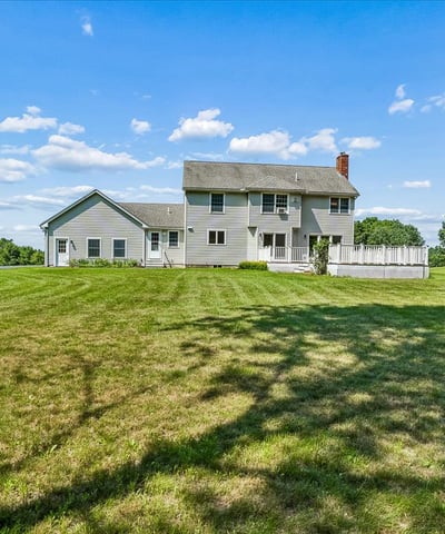 Spacious home on a generous lot, surrounded by greenery and featuring ample outdoor living space.