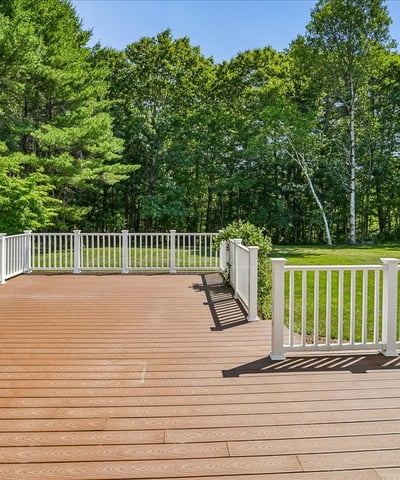 Spacious deck overlooking a large, private yard, perfect for outdoor gatherings and relaxation.