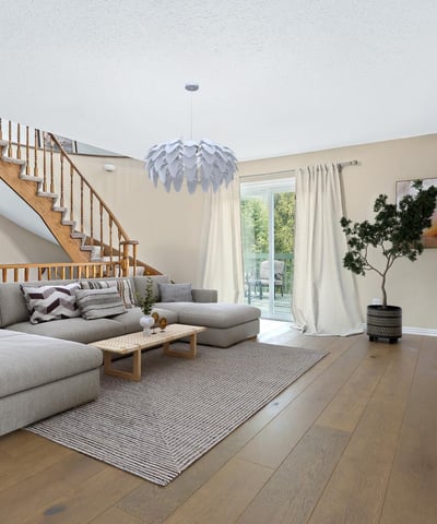Bright and spacious living area features a unique design, natural light, and direct access to the outdoor space.