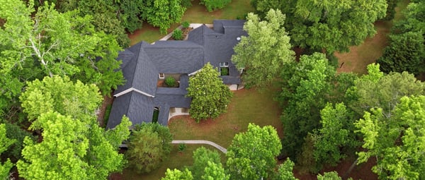 Nestled among lush greenery, this spacious home offers privacy and tranquility on a generous lot.