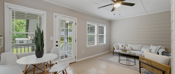 Light-filled sunroom featuring modern furnishings and a cozy seating area, perfect for relaxing or entertaining.