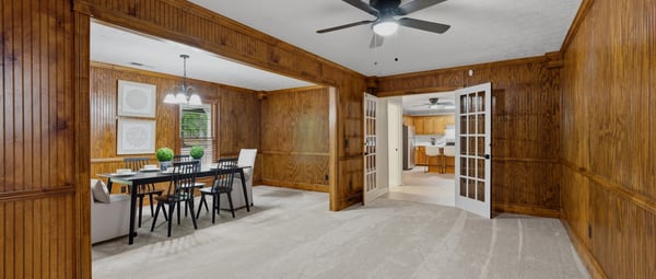 This spacious, multi-purpose area features natural wood accents and accommodates various layouts for living and dining.