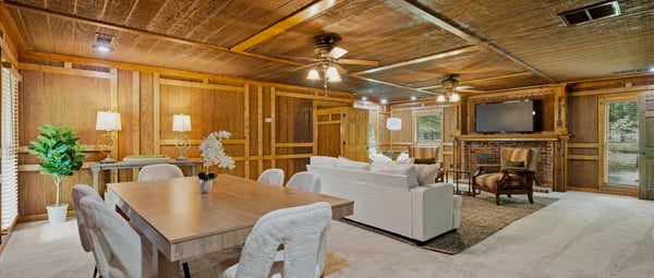 Spacious living area features natural wood accents, premium furnishings, and ample space for gatherings or relaxation.