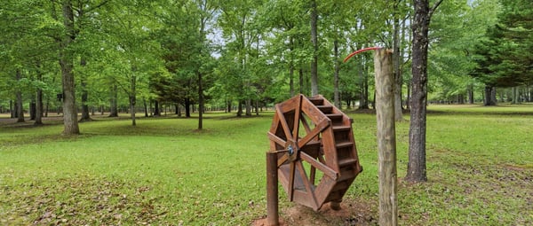 Discover a unique property featuring beautiful natural surroundings and an eye-catching vintage water wheel.