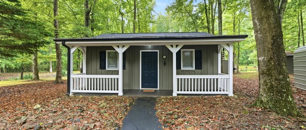 Cottage features a covered front porch, an open living area, kitchenette, private bedroom, and full bath. A versatile space that offers flexibility and functionality, perfect for hosting guests, working from home, or creating a studio or hobby space.