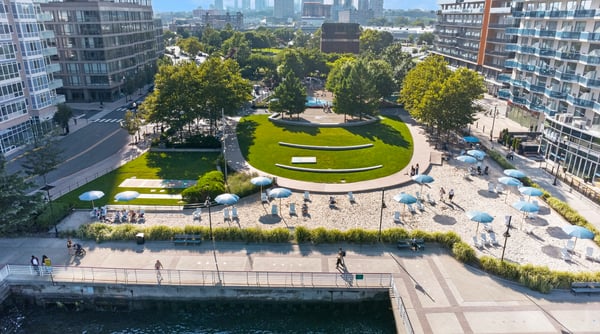 Spacious waterfront property surrounded by lush greenery and vibrant community spaces, perfect for an active lifestyle.
