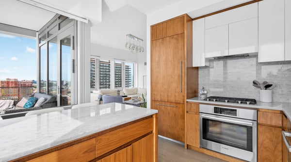 Modern kitchen featuring sleek cabinetry and panoramic views, seamlessly blending functionality with urban living.