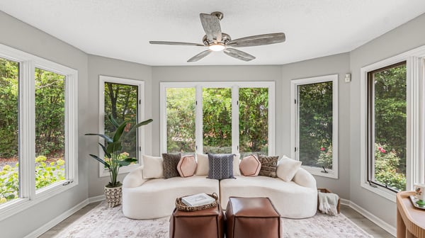 Bright and airy sunroom featuring large windows, perfect for relaxation or entertaining with nature views.