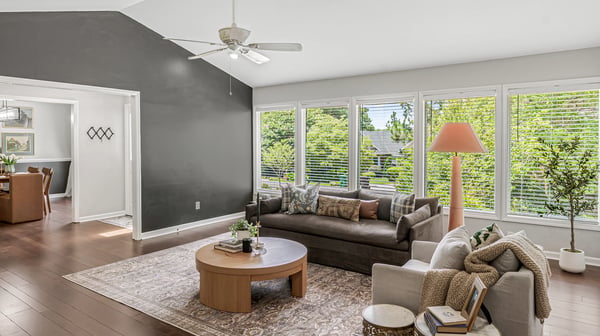 Bright and spacious living area featuring large windows, modern furnishings, and an inviting atmosphere.
