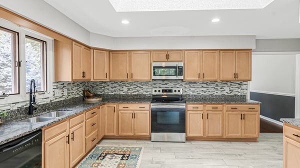Contemporary kitchen features modern appliances, ample cabinetry, and a unique tile design, perfect for culinary enthusiasts.