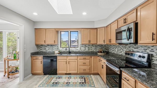 Bright and functional kitchen featuring modern appliances, abundant cabinetry, and natural light throughout the space.