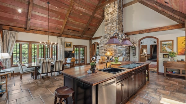 Experience this inviting kitchen, featuring a spacious island, rustic details, and ample natural light.