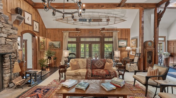 Spacious, inviting living area featuring a striking stone fireplace and artistic touches throughout.