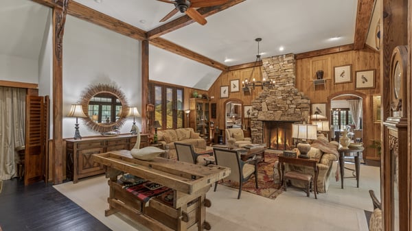 Spacious great room featuring a stunning stone fireplace and wood accents, perfect for entertaining and relaxation.