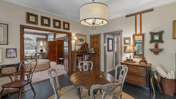 Cozy dining area featuring vintage decor, seamless flow to adjoining living space, and warm ambiance.