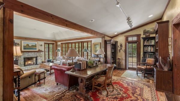 This inviting living space features warm wood accents, a cozy fireplace, and abundant natural light.