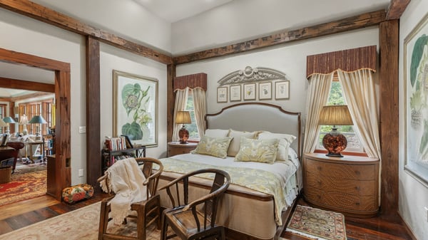 Cozy bedroom featuring natural light, warm wood accents, and unique artwork for a personal touch.