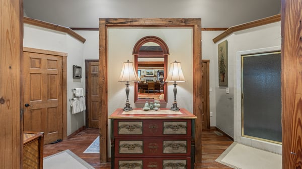 This inviting bathroom features rustic wooden accents and ample natural light, enhancing its welcoming atmosphere.