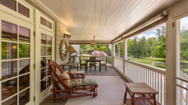 Spacious porch featuring comfortable seating and scenic views, perfect for relaxing and entertaining outdoors.
