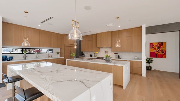 Modern chef s kitchen with two oversized islands, sleek cabinetry, and premium appliances. This Paradise Valley home offers functional design and high-end finishes ideal for gatherings.