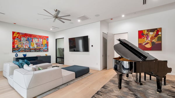 Open living room with modern furnishings, wood flooring, and built-in entertainment wall. This Paradise Valley home offers a blend of style, comfort, and functional living space.