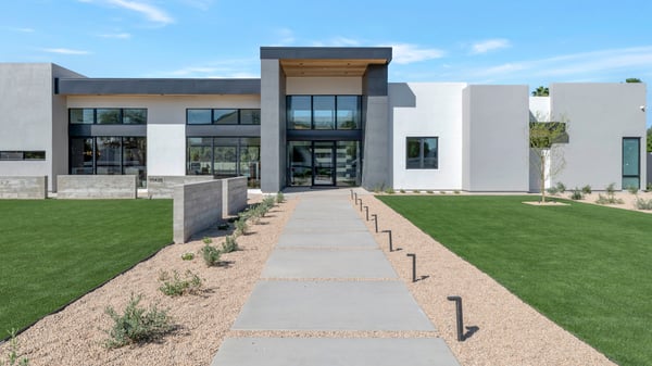 Detailed view of the home s contemporary exterior with clean lines and large glass windows. This Paradise Valley property emphasizes modern architecture and upscale design.
