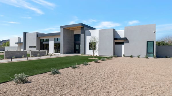 Exterior angle highlighting the home s modern design, large windows, and structured lines. This Paradise Valley property combines luxury finishes with desert-friendly landscaping.