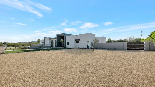 Clean and modern north-facing fa ade with gated entry and privacy wall. This Paradise Valley home offers security, sleek design, and a spacious setting.