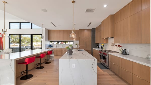 Sleek kitchen featuring a large island, quartz countertops, and custom cabinetry. This Paradise Valley home is designed for entertaining with premium appliances and open flow.