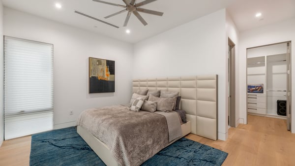 Spacious bedroom with modern flooring, soft natural light, and convenient closet access. This Paradise Valley home offers flexible and functional living spaces